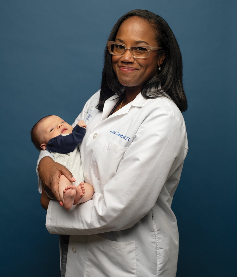 Dr. Lisa Saul with baby in arms